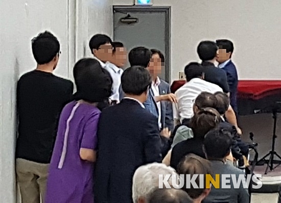 약사회 임총에서 멱살잡이가 벌어지자 주위에서 말리고 있다.